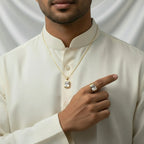 VASTUKOSHA white topaz gemstone pendant and ring set worn by a man in a traditional cream-colored kurta