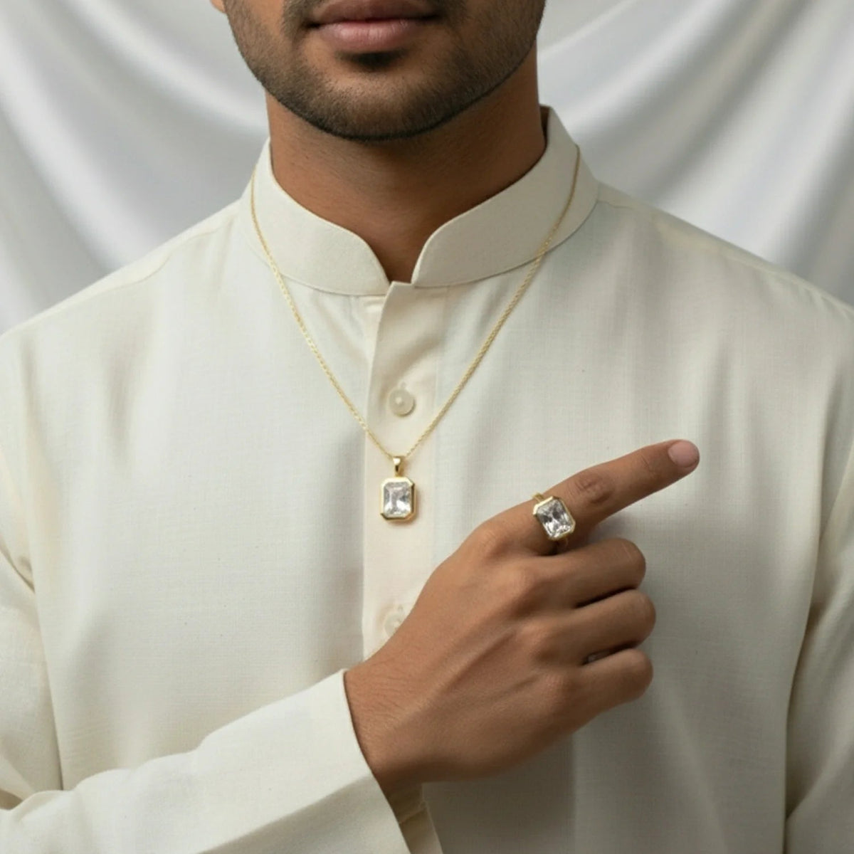 VASTUKOSHA white topaz gemstone pendant and ring set worn by a man in a traditional cream-colored kurta