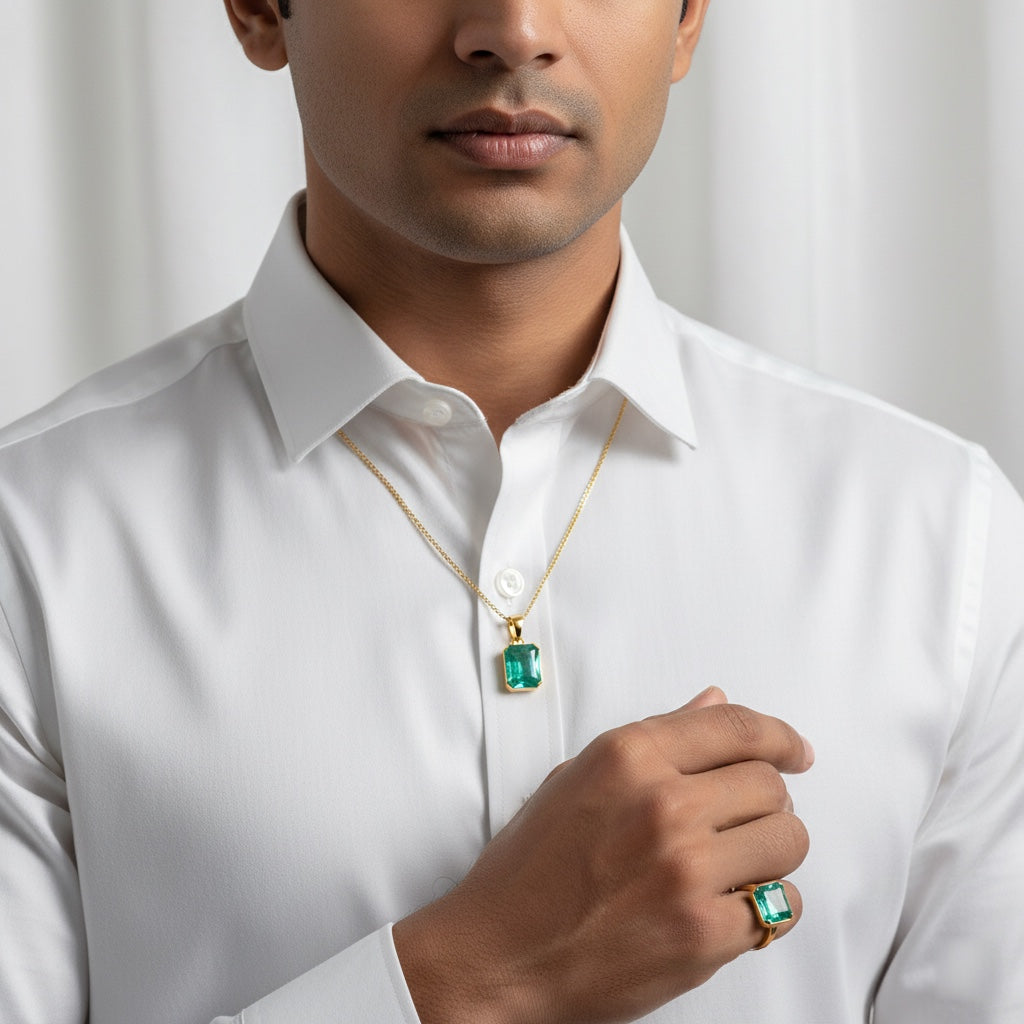 VASTUKOSHA Zambian emerald pendant and ring set in gold, worn by a man in a white shirt for astrological practice.